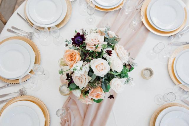 Overhead view of table with white plates and flowers for Jennifer & Lars' Wedding