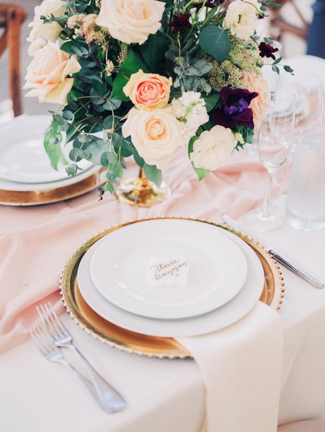 Single place set of white plate, flowers and pink table cloth for Jennifer & Lars' Wedding