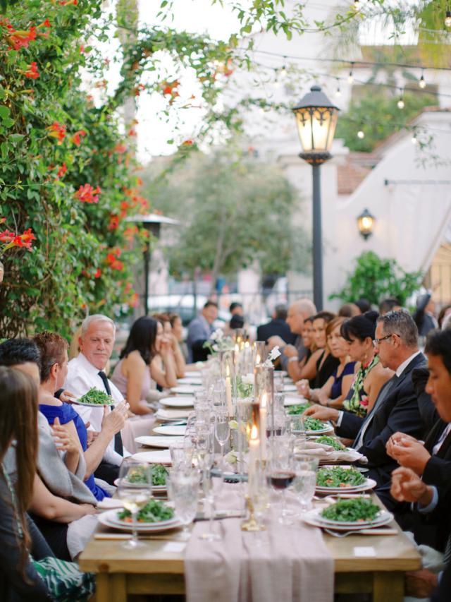 People eating at long table for Jammie & Duncan's Wedding