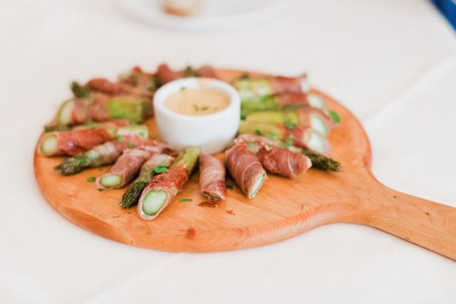 Wooden plate of food on table for Jennifer & Lars' Wedding