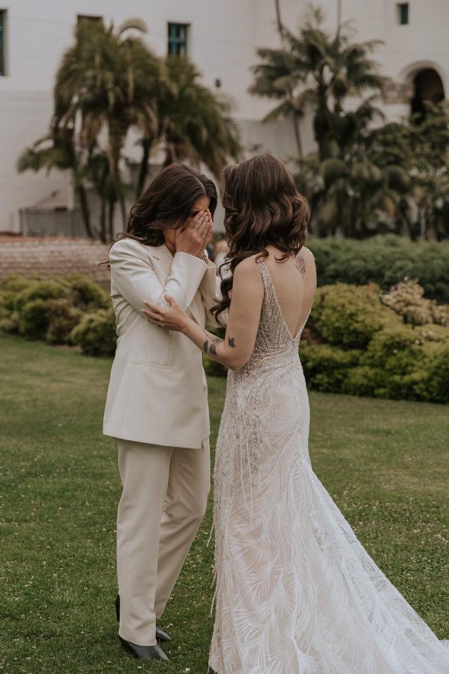 Bride and groom, with hands over faces, embracing each other for Ivanka & Victoria's wedding