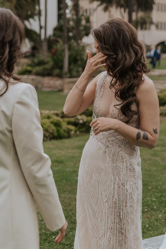 Mid shot of the bride touching her eye for Ivanka & Victoria's wedding