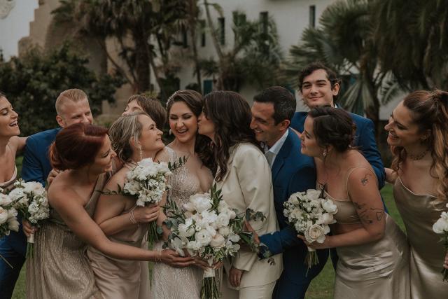 Wedding party group hugs with everyone laughing for Ivanka & Victoria's wedding