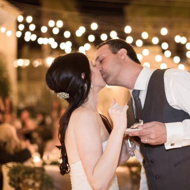 Bride & Groom Kissing after Eating Cake for Kelly & Jason’s Wedding