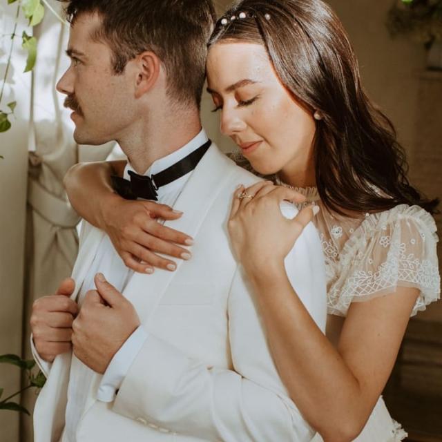 Bride holding groom from behind for Paulina & Cam’s Wedding